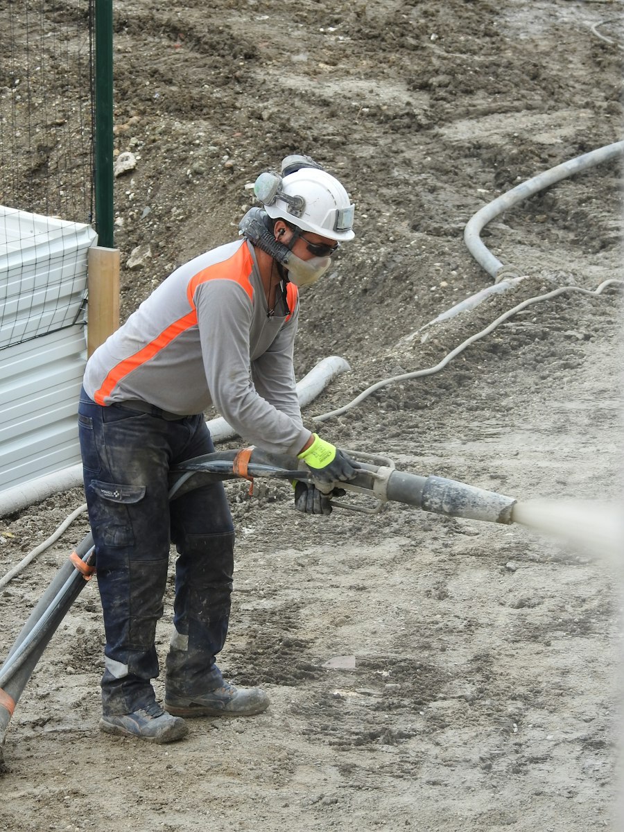 Worker spray-applying a cement-based lining