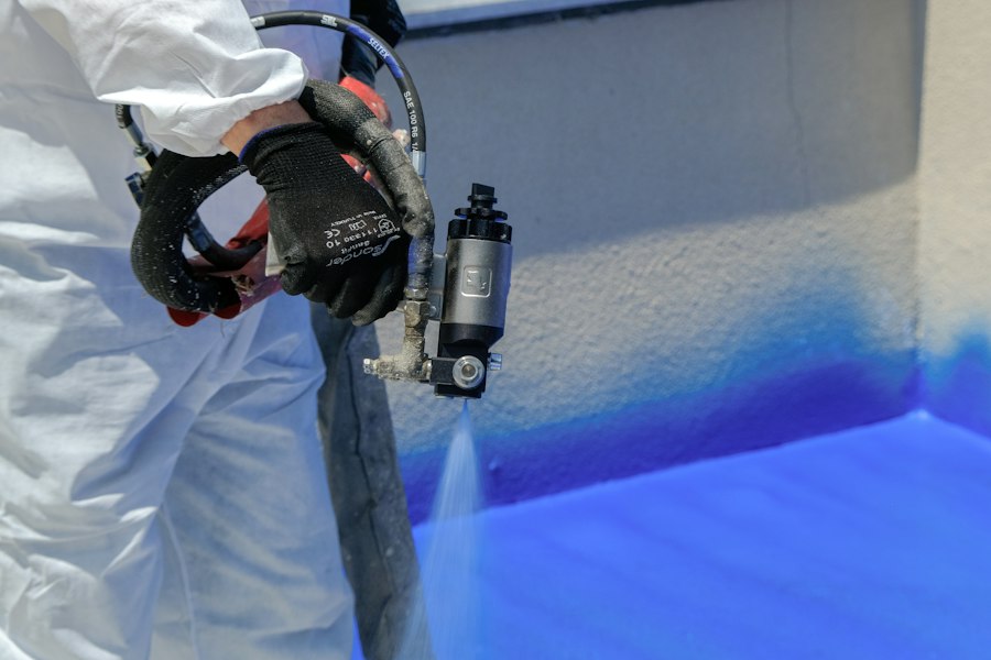 Close-up of a spray gun applying coating
