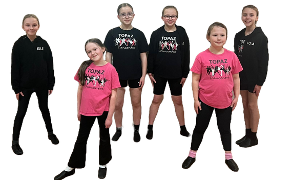 Six pre-teen girls, posed symmetrically. They are wearing a range of Topaz Branded items; hoodies, jumpers and T shirts, with black legwear and black jazz shoes.