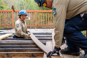 CCC Corpsmembers install decking at a nature center.