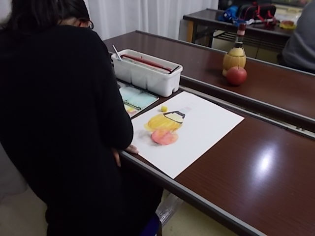 小学6年生がワインとリンゴを描いている様子