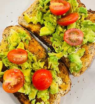 Fresh avocado on wholegrain toasted bread with succulent ripe tomatoes prepared in our cafe.