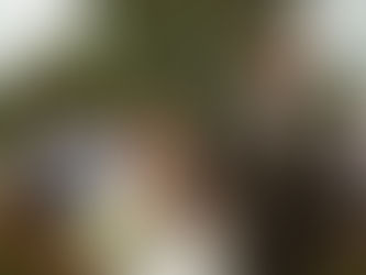 A bride and groom walk back down the aisle laughing.