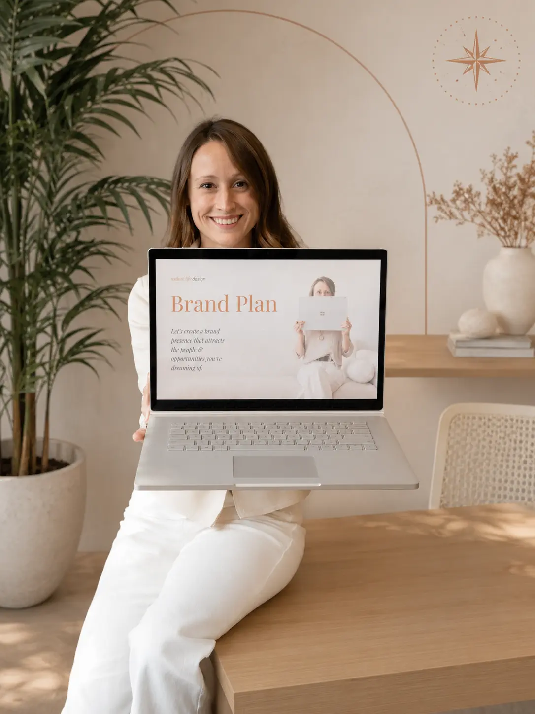 Alexandra Halthen showing a brand plan on a laptop