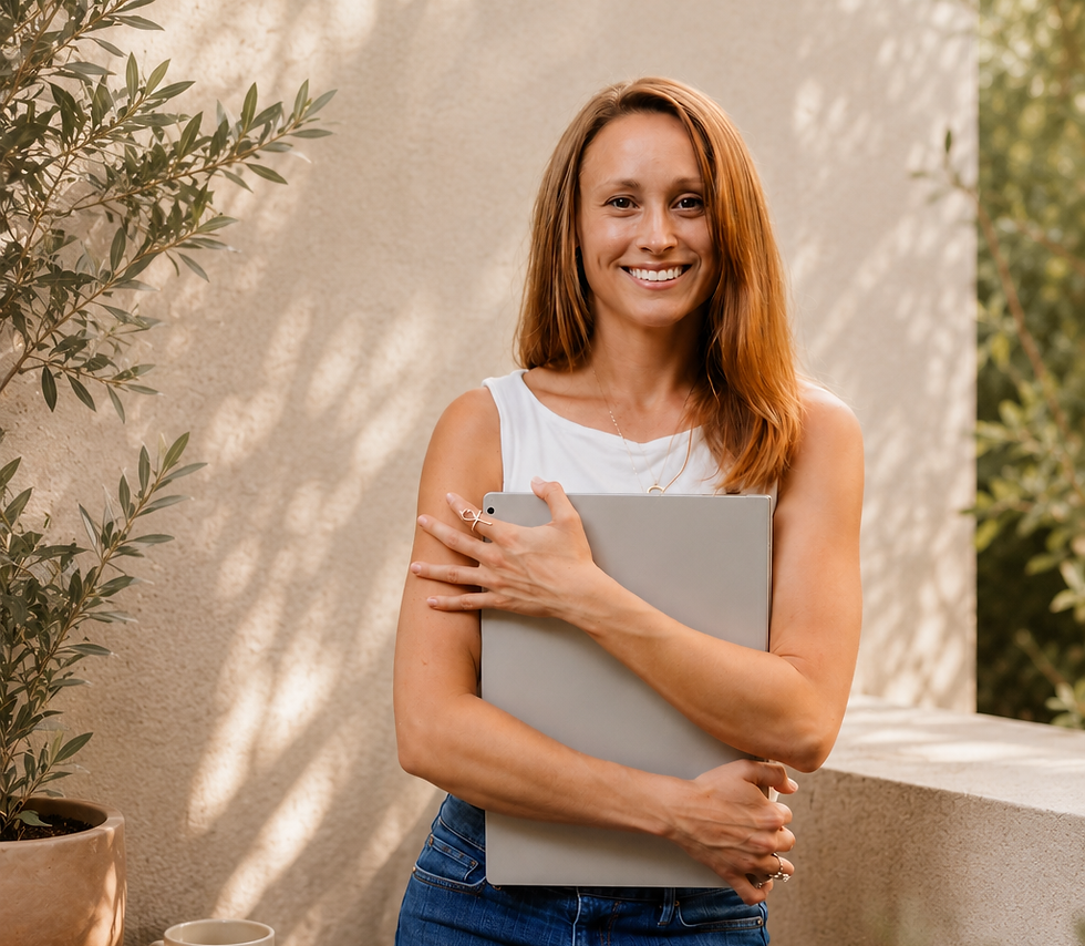 Alexandra Halthen founder of Radiant Life Design smiling with laptop