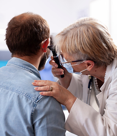 older-doctor-performs-ear-examination.jpg