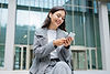 young-woman-using-cellphone-with-wireless-earphone-2026-01-08-23-08-41-utc.jpg