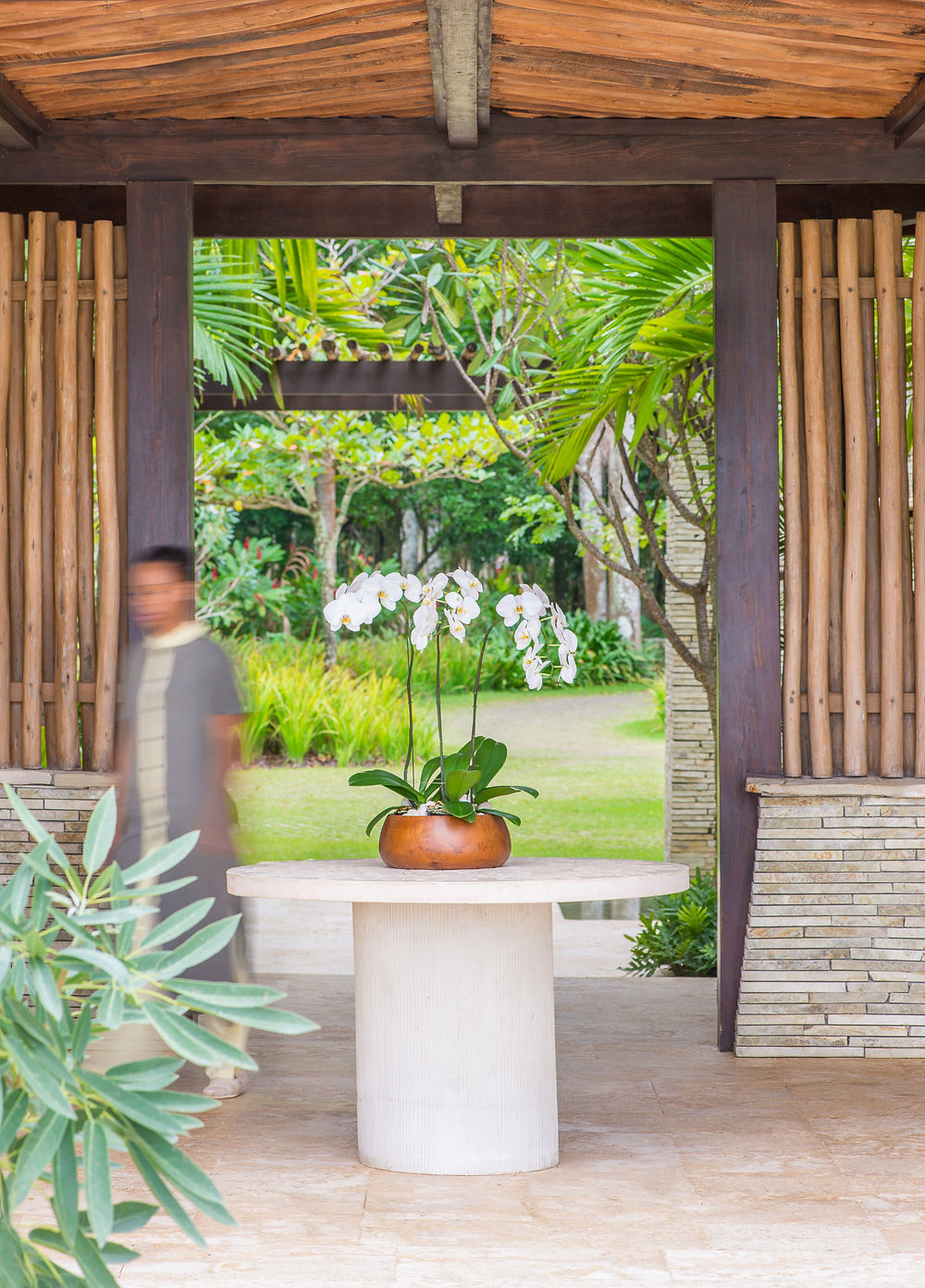 Amanera entryway with white orchids and lush garden