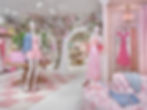 Pink clothing boutique with floral decor and mannequins