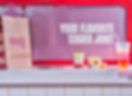 KFC Saucy bag, dipping sauces, and drink with slogan