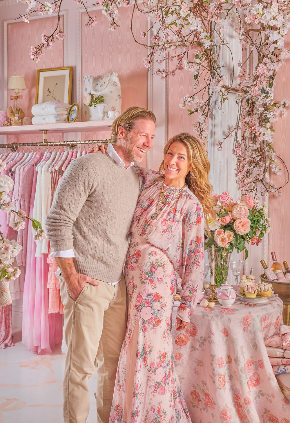 Couple smiling in a pink floral Love Shack Fancy boutique
