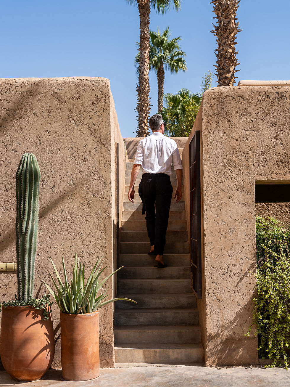 Man climbing outdoor stairs of a Marrakech villa