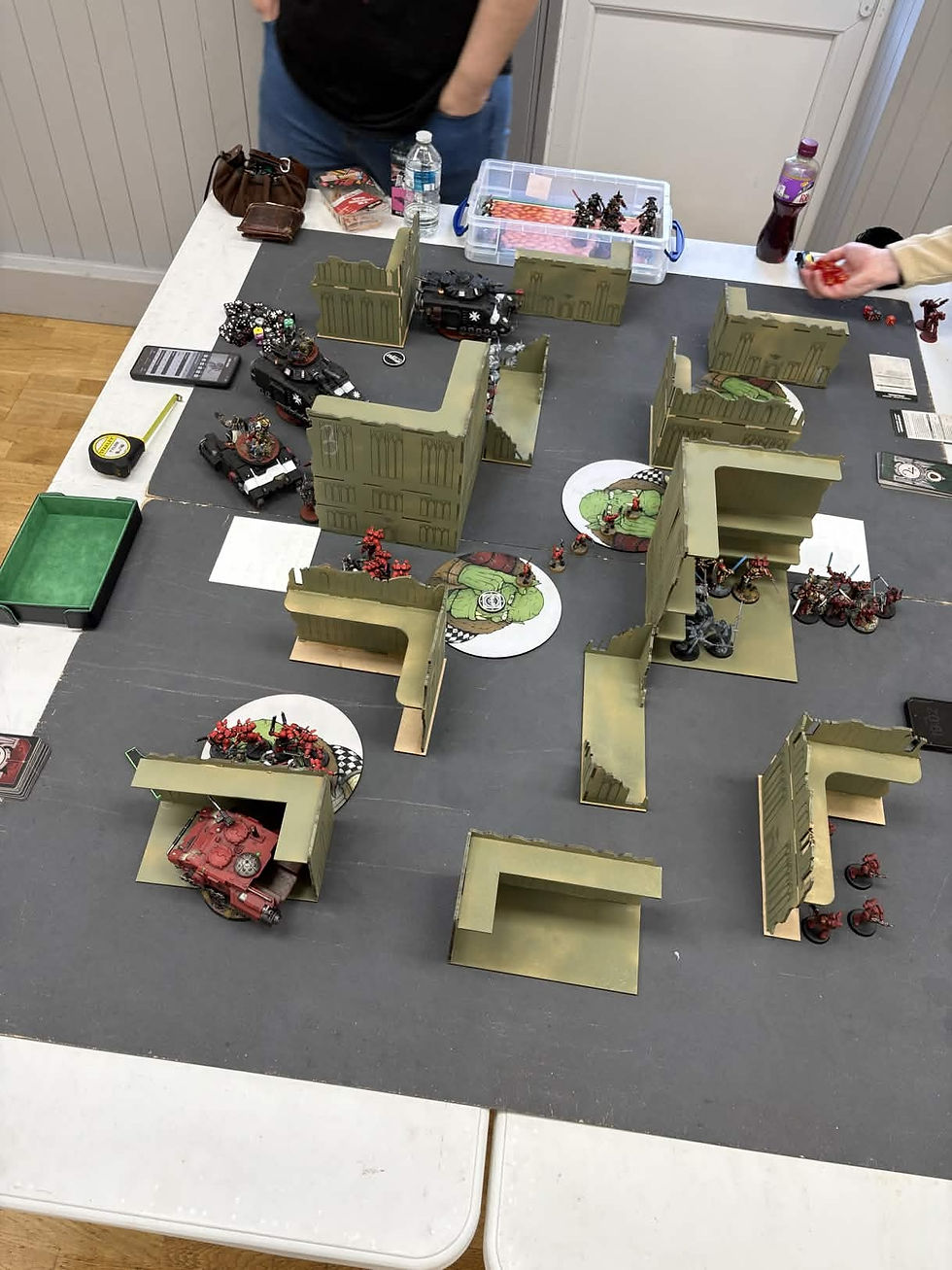 A beautifully detailed dungeon crawler gaming board with Warhammer Quest miniatures set up for play