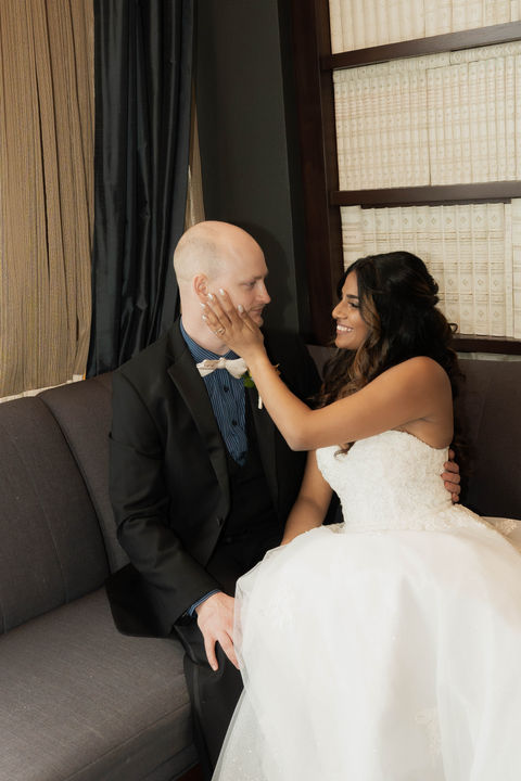 Intercultural wedding couple with Indian bride in romantic nook at The Pfister Hotel Milwaukee Wisconsin