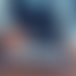 Man in blue shirt examines a clipboard with a magnifying glass on a wooden table. A pen and TriSeed logo are visible. Serious mood.