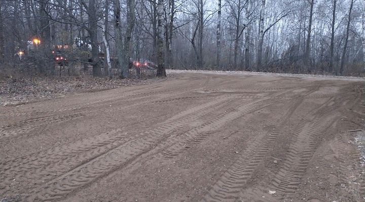 Newly installed gravel driveway in wooded area