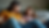 Eye-level view of a parent and teen sitting together on a couch, engaged in a heartfelt conversation