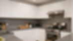 Modern white kitchen with stainless steel appliances