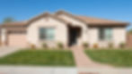 Modern ranch style home with desert landscaping and lawn.