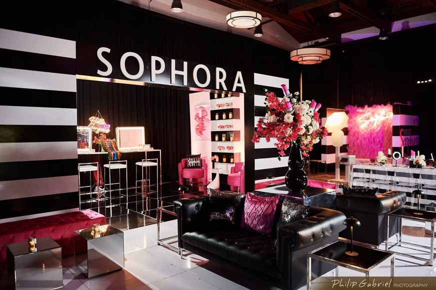 Custom fabrication and installation of an immersive makeup studio featuring a branded storefront, soft seating lounge, beauty-inspired styling, and interactive glam elements for a bat mitzvah celebration.