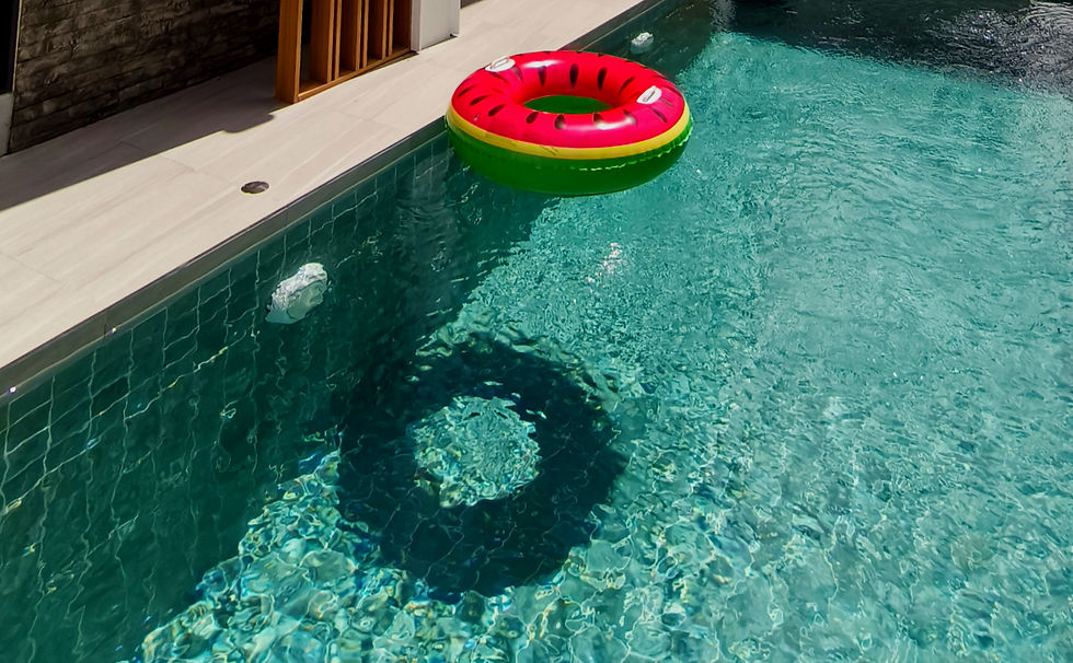 Close-up view of a tranquil private swimming pool surrounded by tropical landscaping