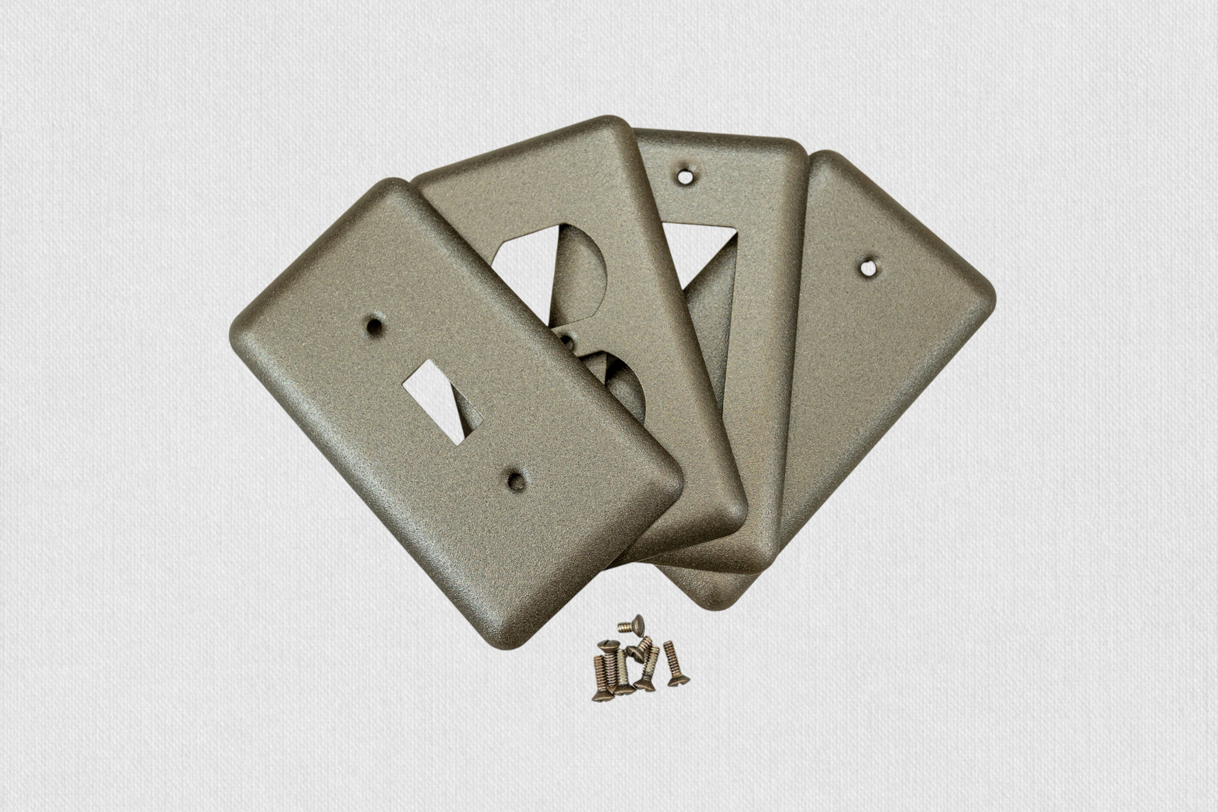 Bronze cast round corner switch plates on white background