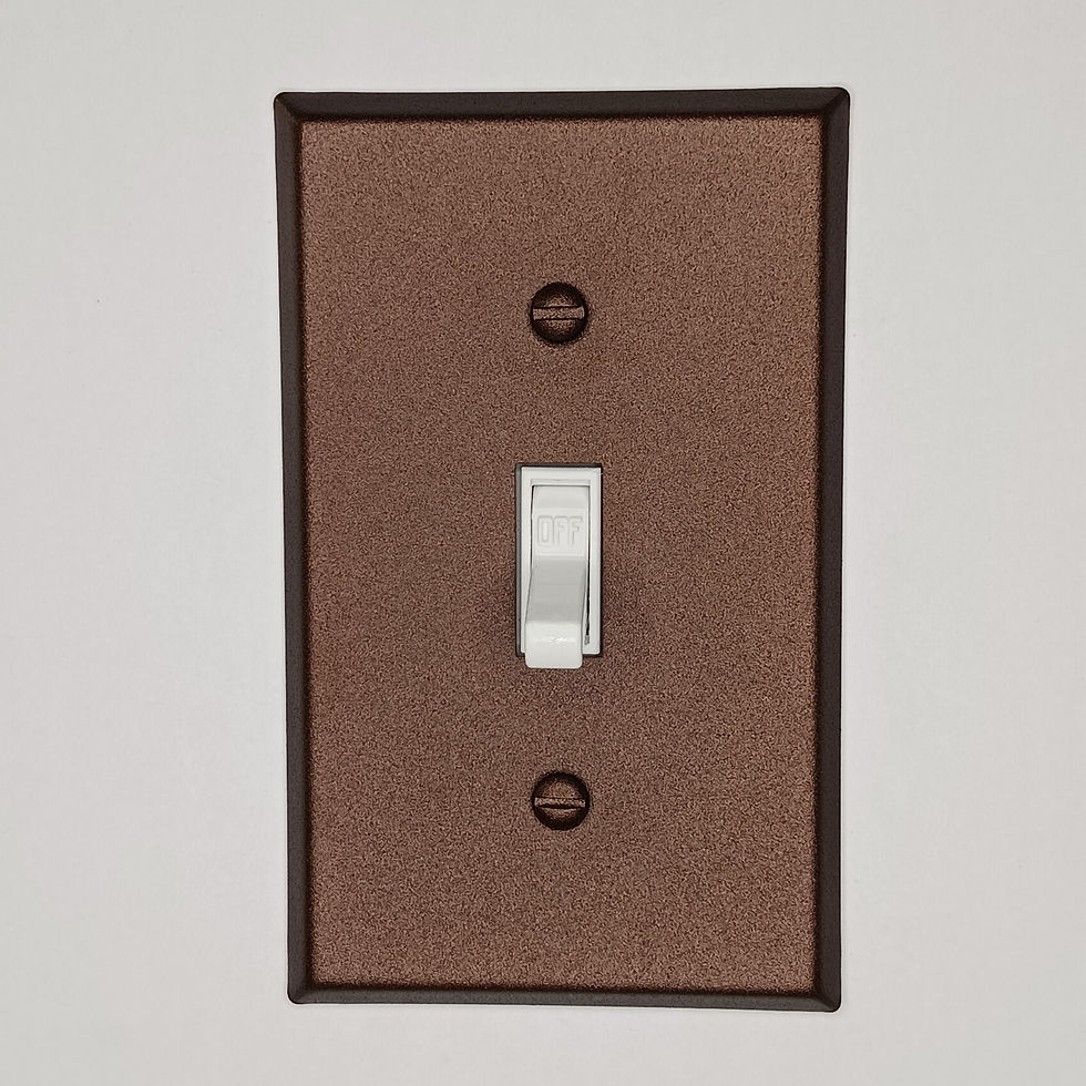 Copper cast toggle switch plate on wall background