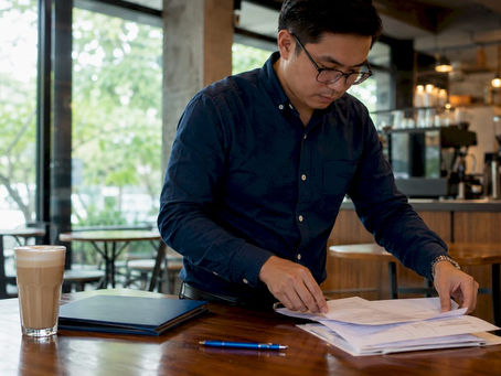 Filipino man organizing documents for UAE attestation