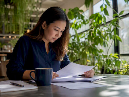 Filipino expat reviewing documents for authentication