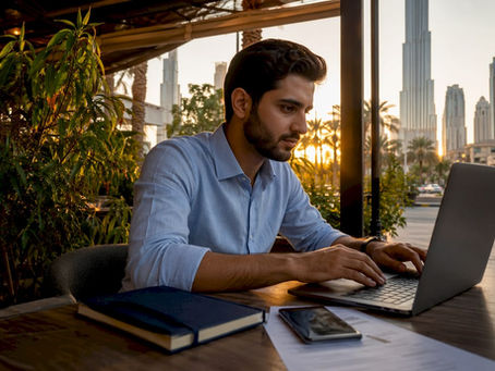 Man setting up UAE PASS at home desk