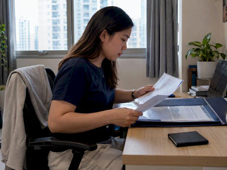Filipino professional reviewing PRC attestation documents