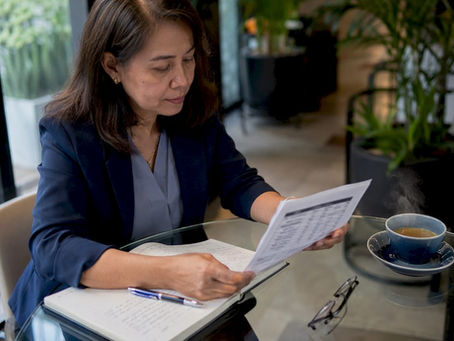 Woman reviewing attestation cost quote papers