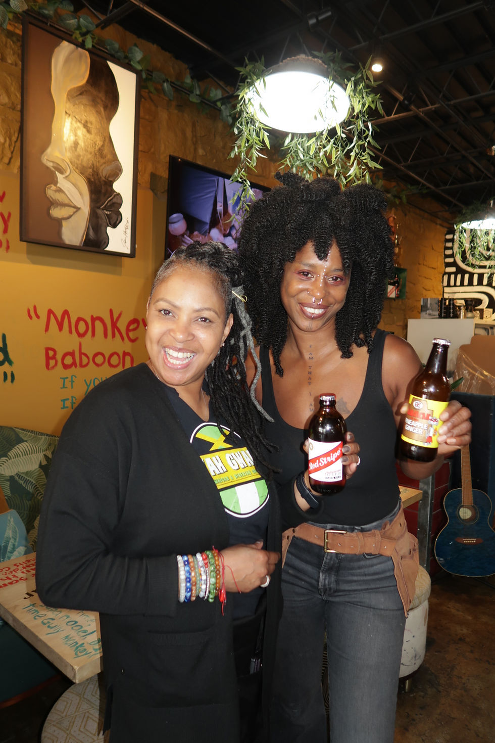 Owner of Wah Gwan Tan and her sister Wing holding jamaican beverages.