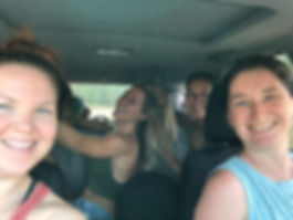 four women in a car smiling during a womens reiki retreat