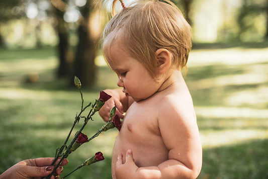 Toddler smelling flowers