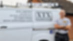 Darrin next to his white work van.