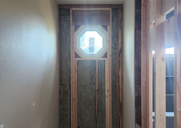 Primary bath after demo, with newly framed and installed Andersen window.