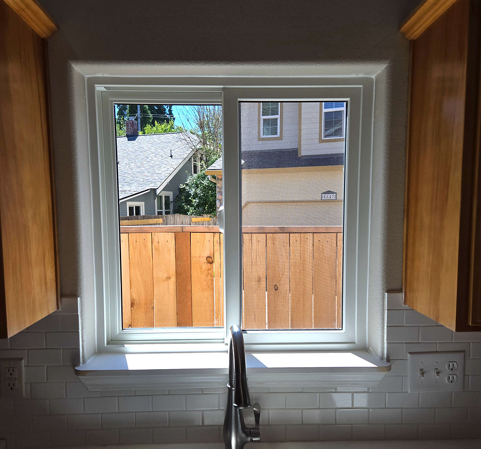 Interior view of a completed Andersen replacement window above a kitchen sink