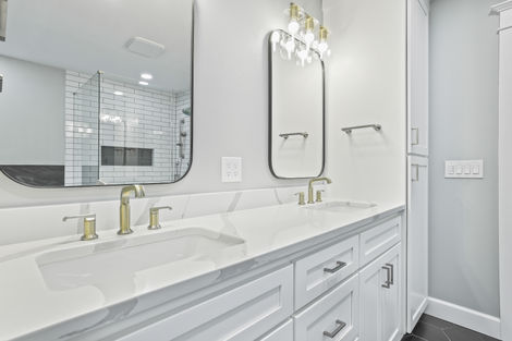 Custom white bathroom vanity with brushed gold hardware and quartz countertop in Beaverton
