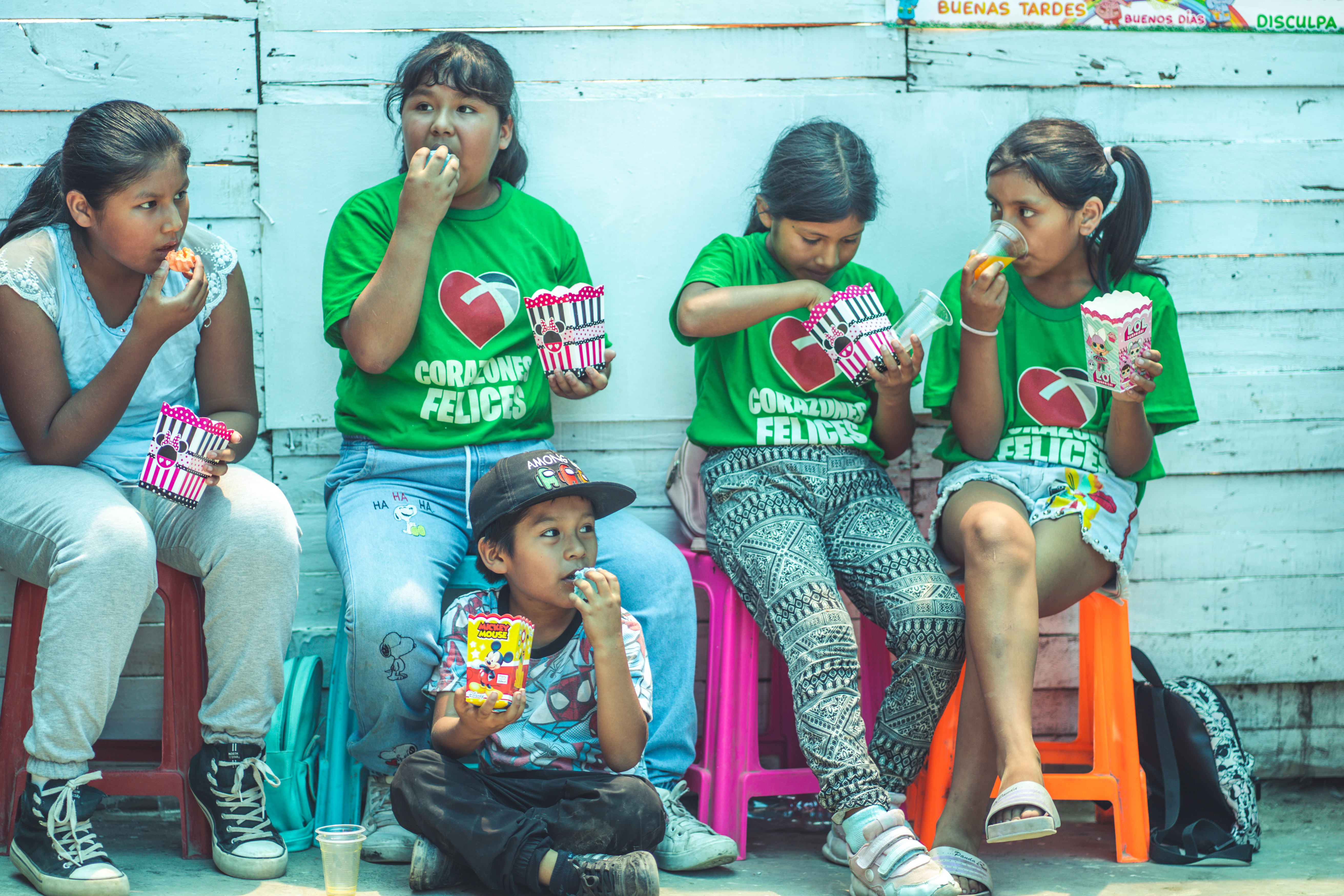 group of kids sitting and eating popcorn