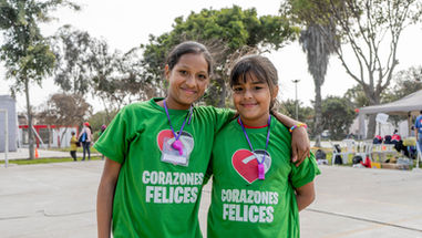 two girls standing arm and arm outside
