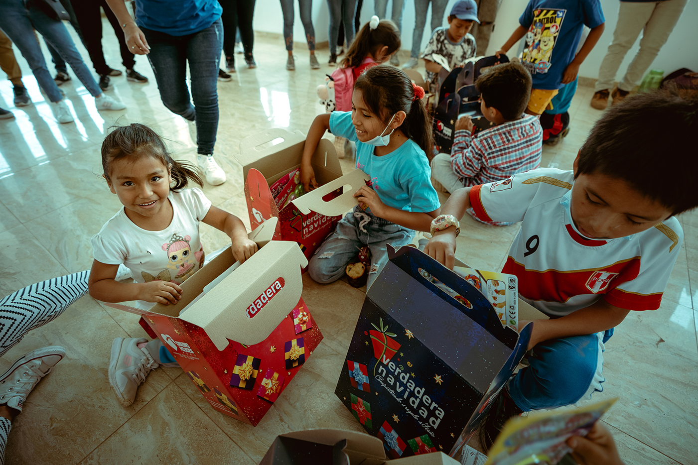Group of kid's opening Christmas Gifts