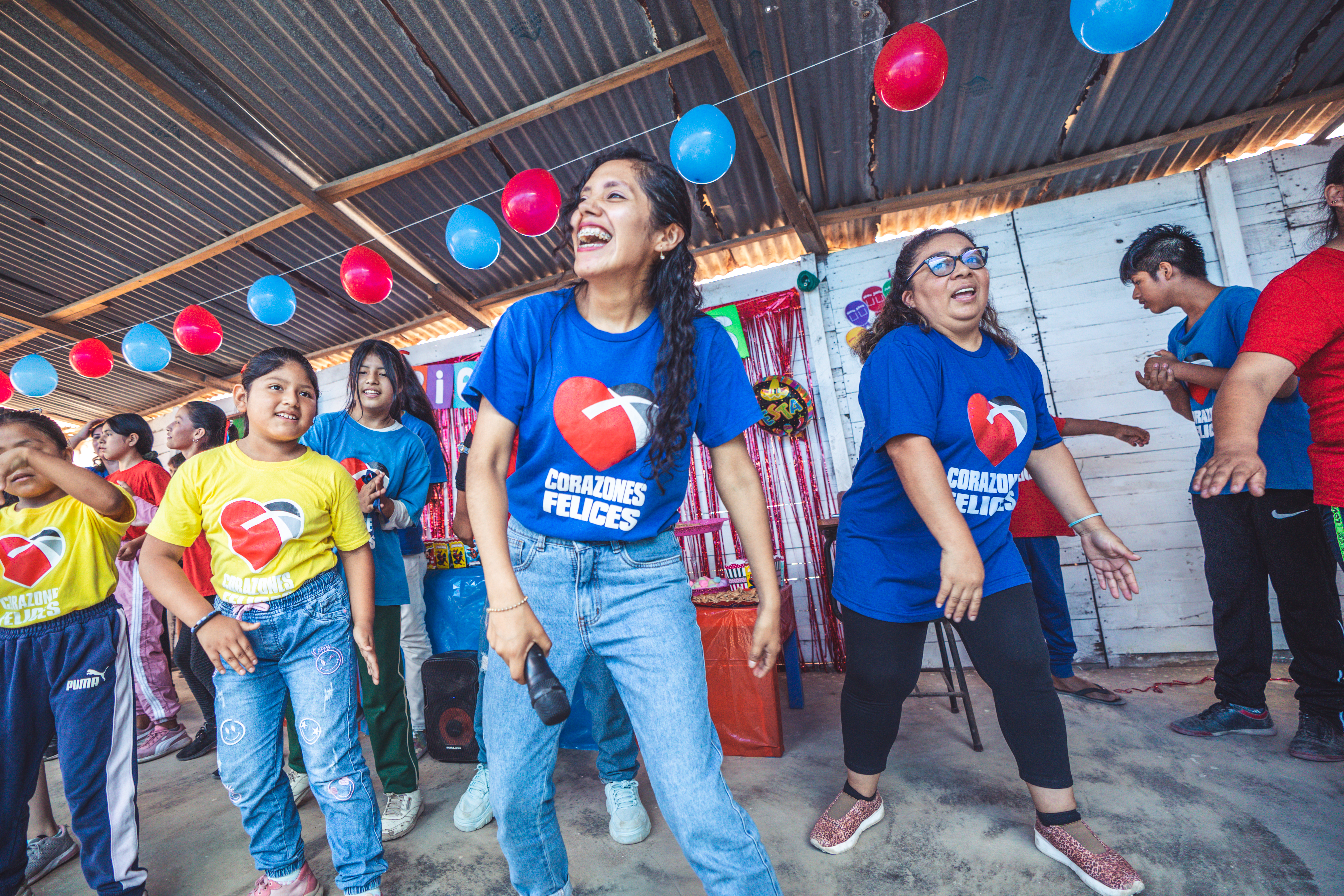 Volunteer leading kids in worship