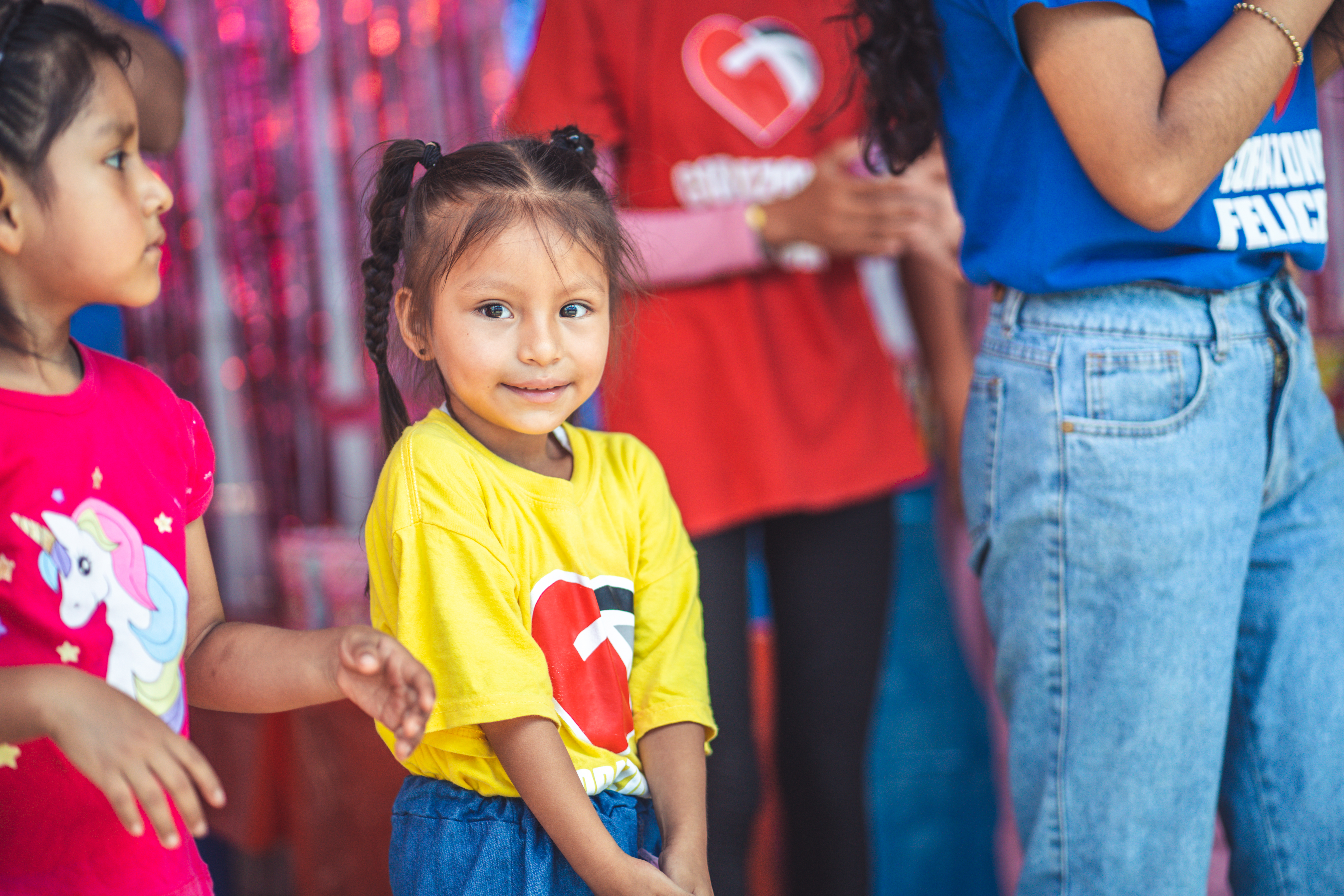 Little Girl standing in front of group of people