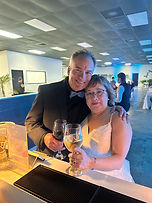 A Groom and Bride cheers at the bar on their wedding day.