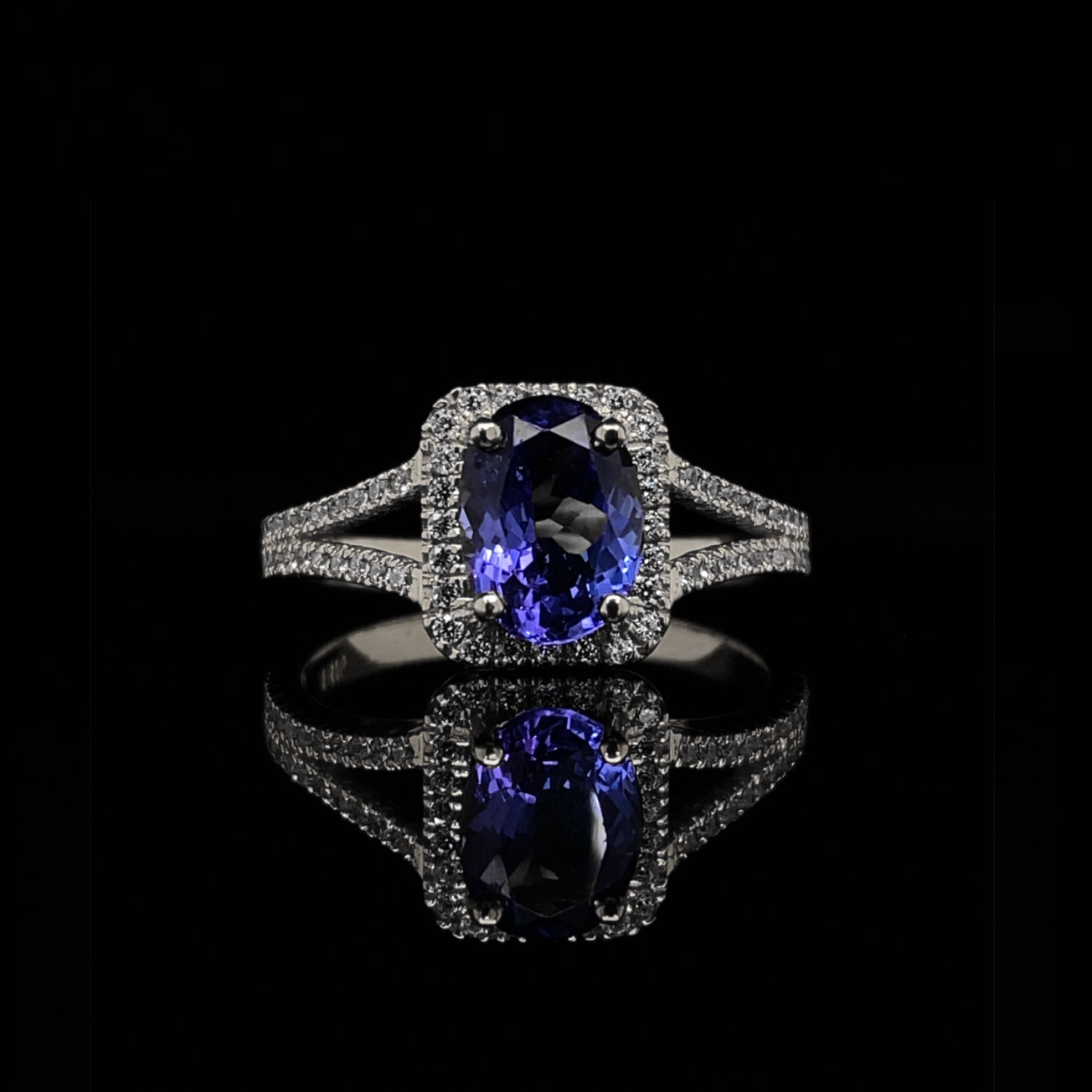 Oval Cut Tanzanite and Diamond Halo Split Shank Engagement Ring in White Gold