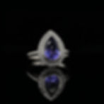 Pear Cut Tanzanite and Cubic Zirconia Bezel Halo Engagement Ring in White Gold