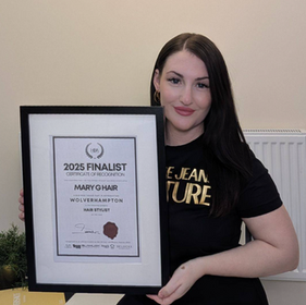 Smiling hairdresser holding finalist certificate for Best Hairdresser of the Year and Best New Salon of the Year 2025 at the Hair and Beauty Awards.
