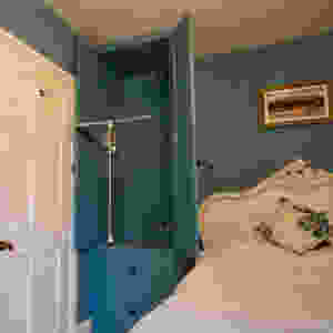 Fitted wardrobe with pull down hanging rail. Automatic light to be fitted when doors are opened.