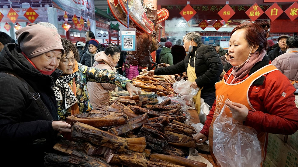 Despite the surge in pork prices, the meat remains a key ingredient for the celebratory dinner on the eve of Lunar New Year [Jason Lee/Reuters]